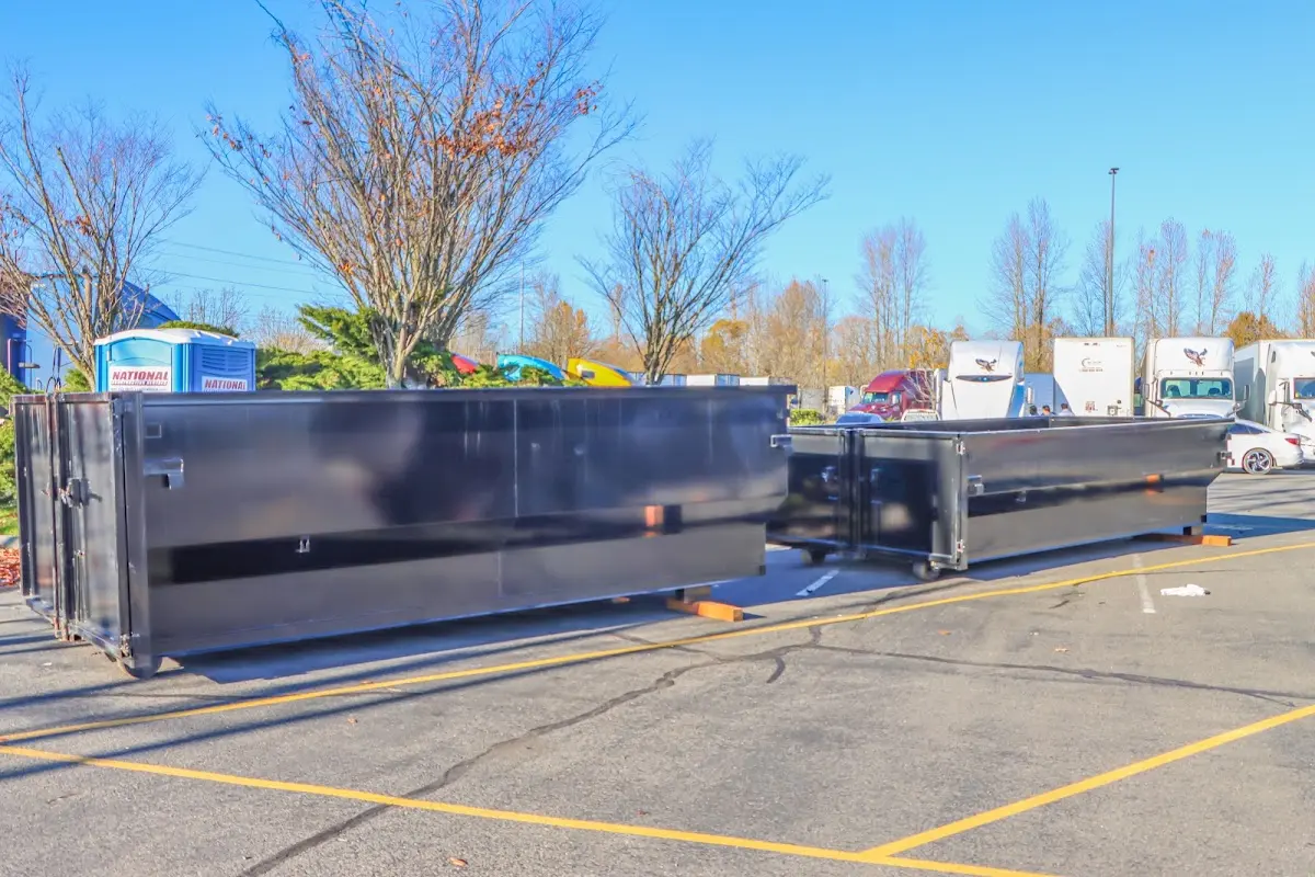 Professional dumpster rental service with roll-off container on residential driveway in Avocado Heights